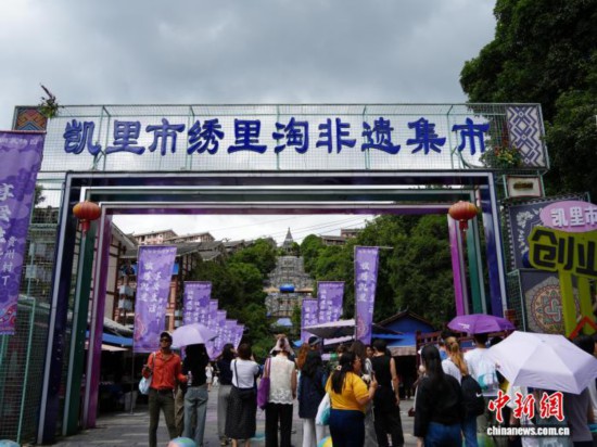 7月4日,贵州省凯里市苗侗风情园内,游客“打卡”绣里淘非遗集市。该集市目前已聚集700余户商家,涵盖刺绣、银饰、蜡染等6000余种非遗文创产品,这些产品既传承了传统手工技艺,又融入现代设计元素,兼具民族韵味与时尚美感,因而吸引了不少海内外游客专程前来“淘宝”。中新社记者 周燕玲 摄